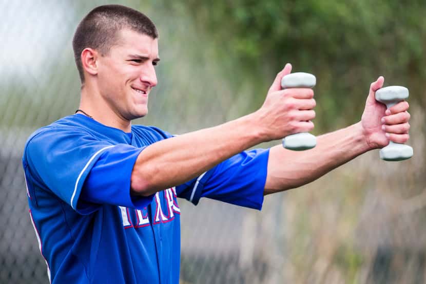 Minor league pitcher Brett Martin lifts hand weights during a spring training workout at the...