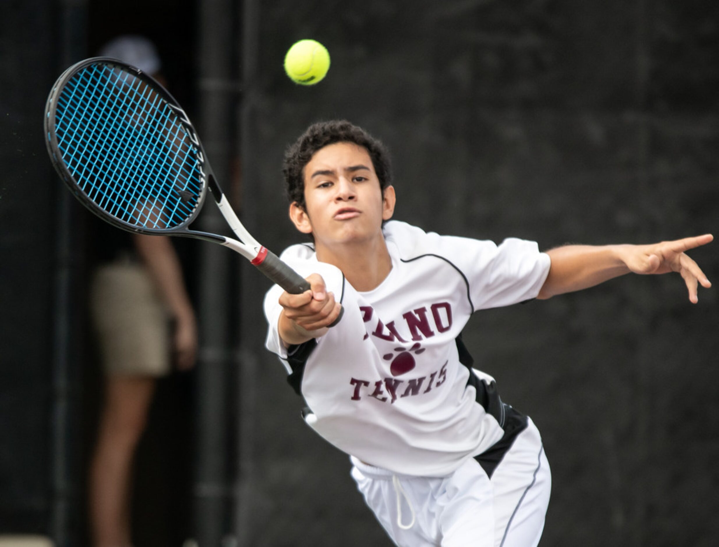 Plano's Herman Aguirre returns the ball in a doubles match with teammate Edward Shteyn in a...