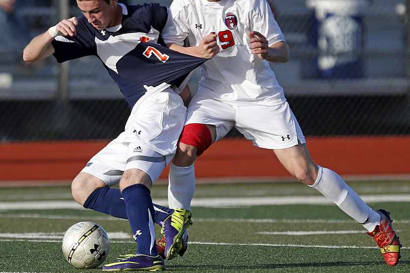 Wakeland High School's Corey Cantor (7) battles for the soccer ball against Centennial High...