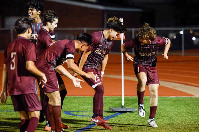 Frisco Heritage players celebrate after a goal during the second half of a bi-district...