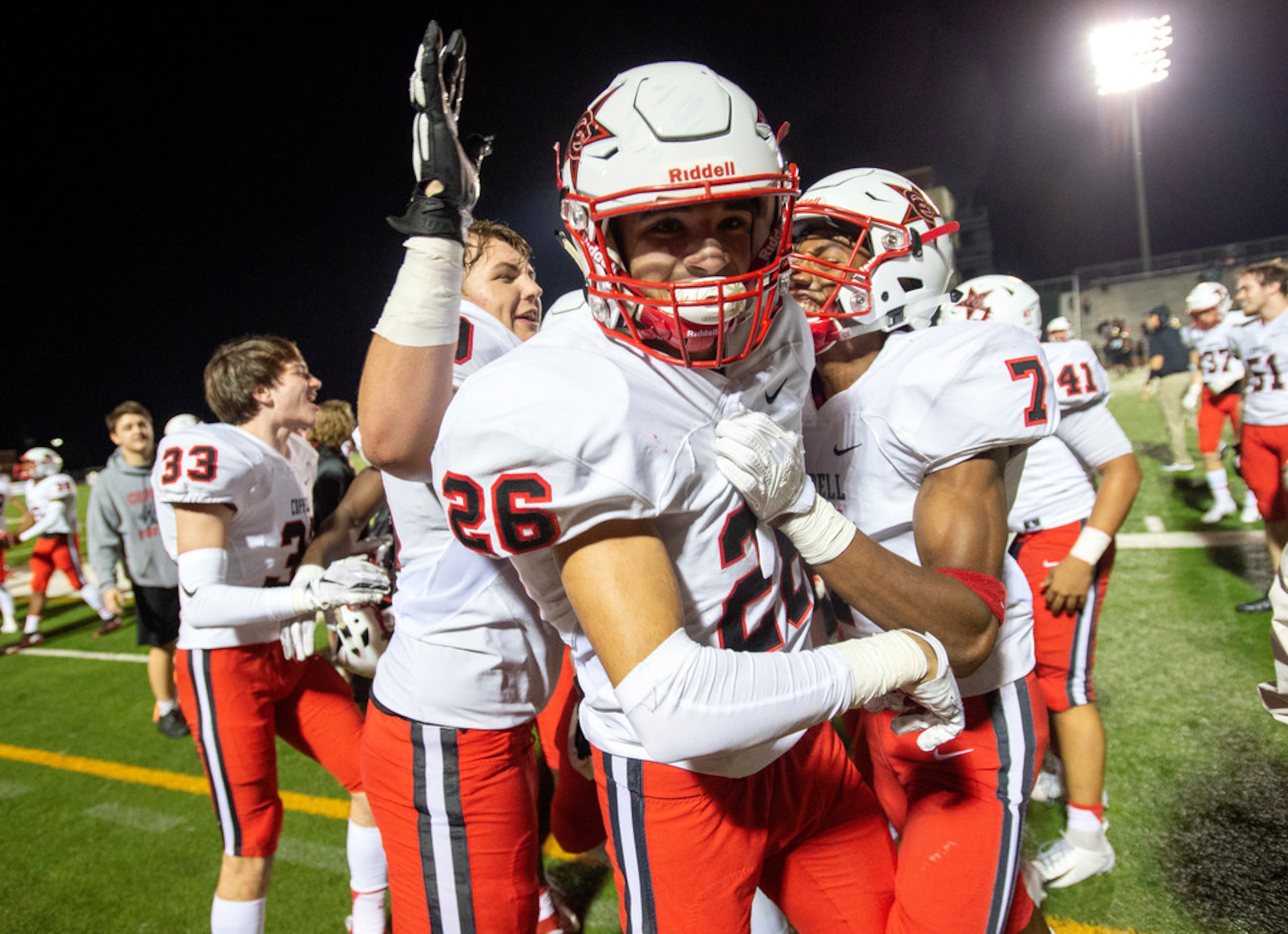 Coppell senior defensive back Noah Snelson (26) is congratulated by junior lineman Parker...