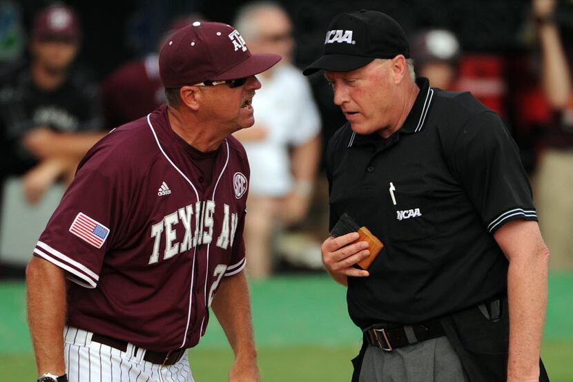 Texas A&M head coach Rob Childress, left, argues with home plate umpire Frank Sylvester...