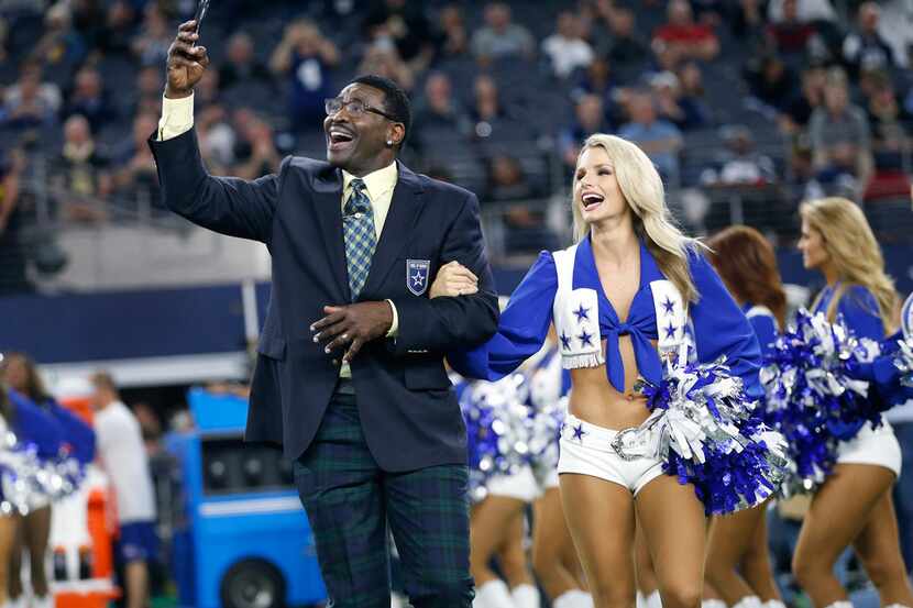 Former Dallas Cowboys wide receiver Michael Irvin shoots a video of himself being escorted...