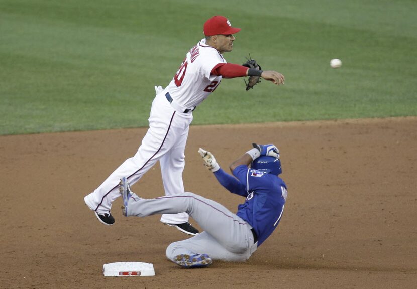 Texas Rangers' Elvis Andrus, right, is forced out at second base as Washington Nationals...