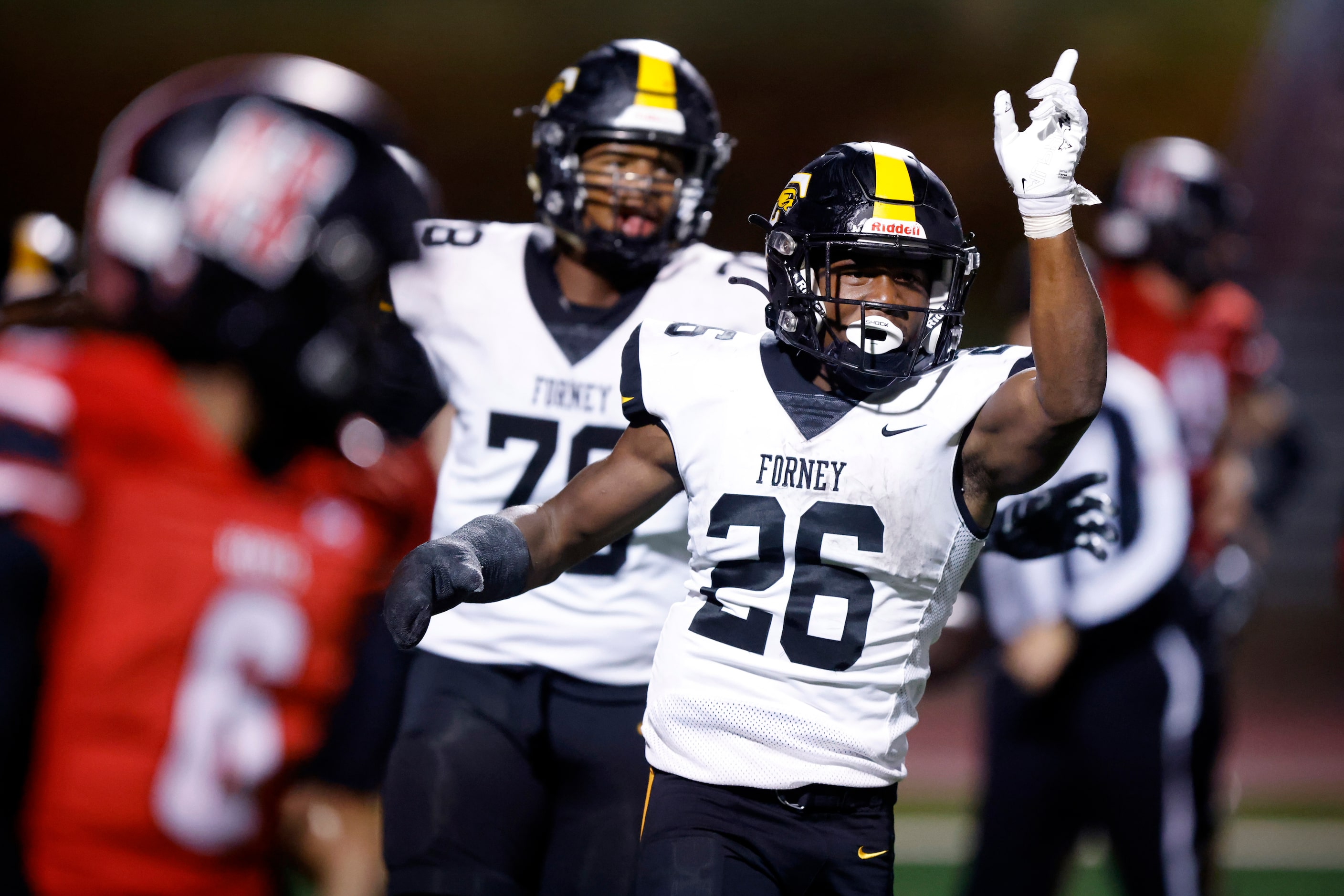 Forney running back Javian Osborne (26) celebrates his a long touchdown run on a third and...