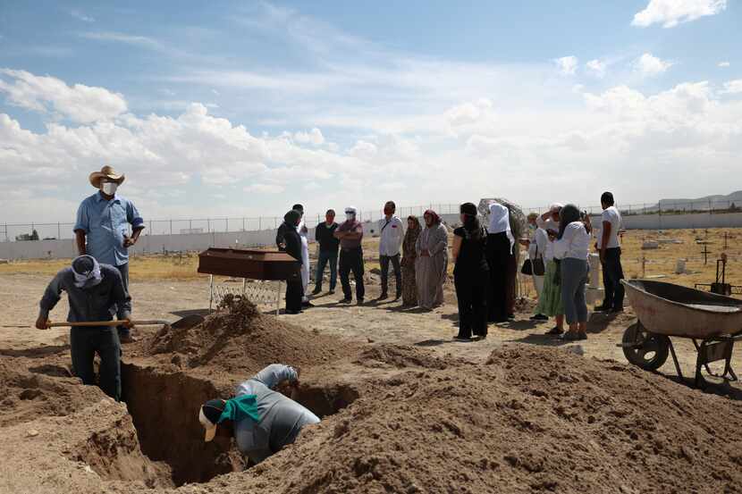 Cemetery workers dig a grave in a cemetery in Ciudad Juarez, Mexico, on June 11, 2020, to...
