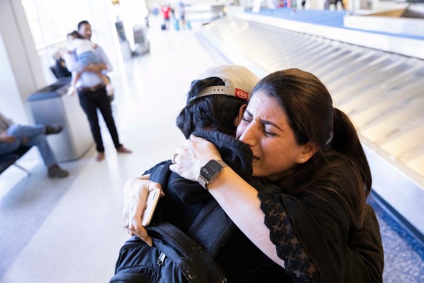 Atefa Sharifi (right) hugged her son Saeed Sharifi, 15, after being reunited on Tuesday at...