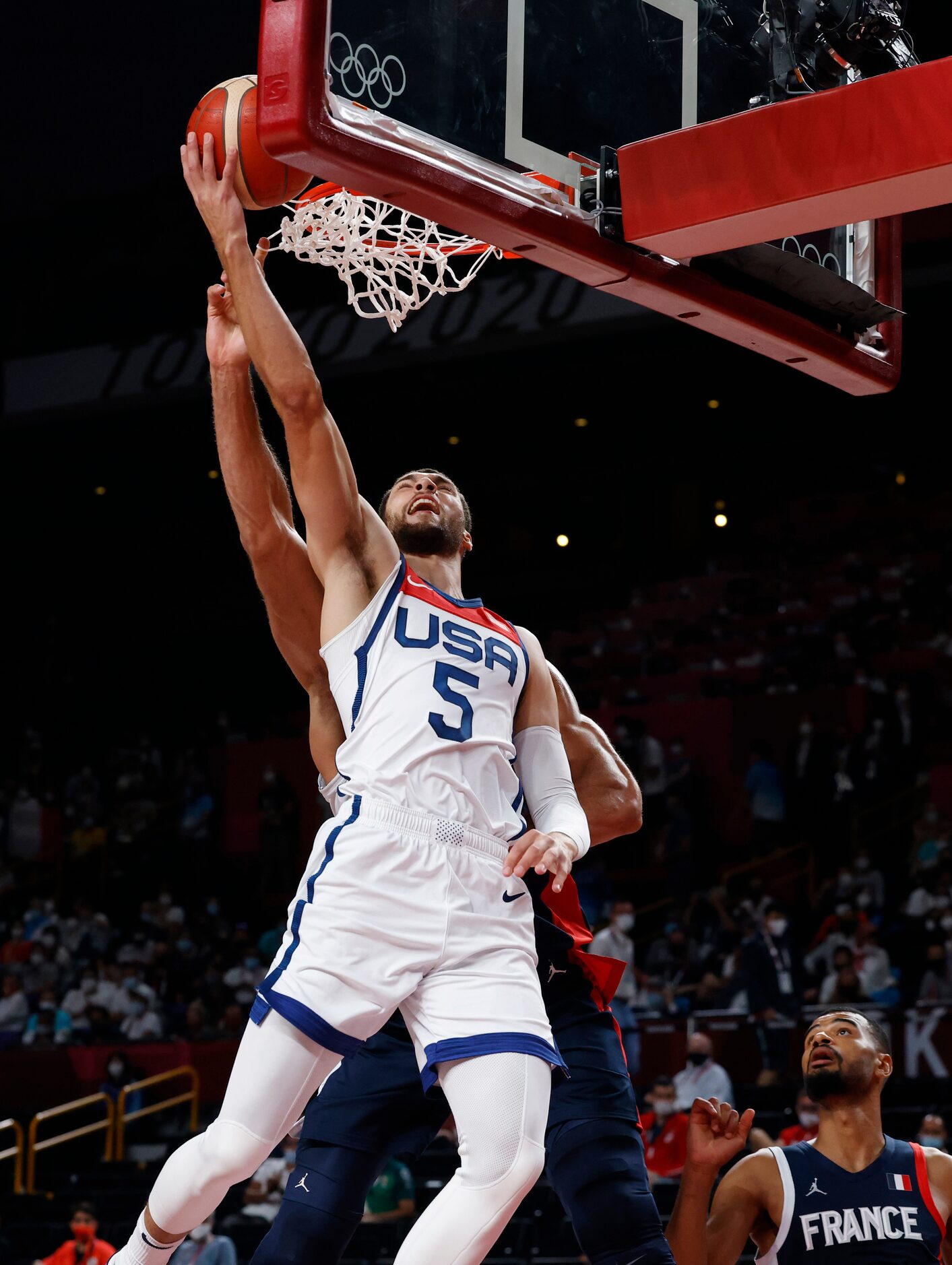 USA’s Zach Lavine (5) is fouled on a shot attempt by France’s Rudy Gobert (27) during the...