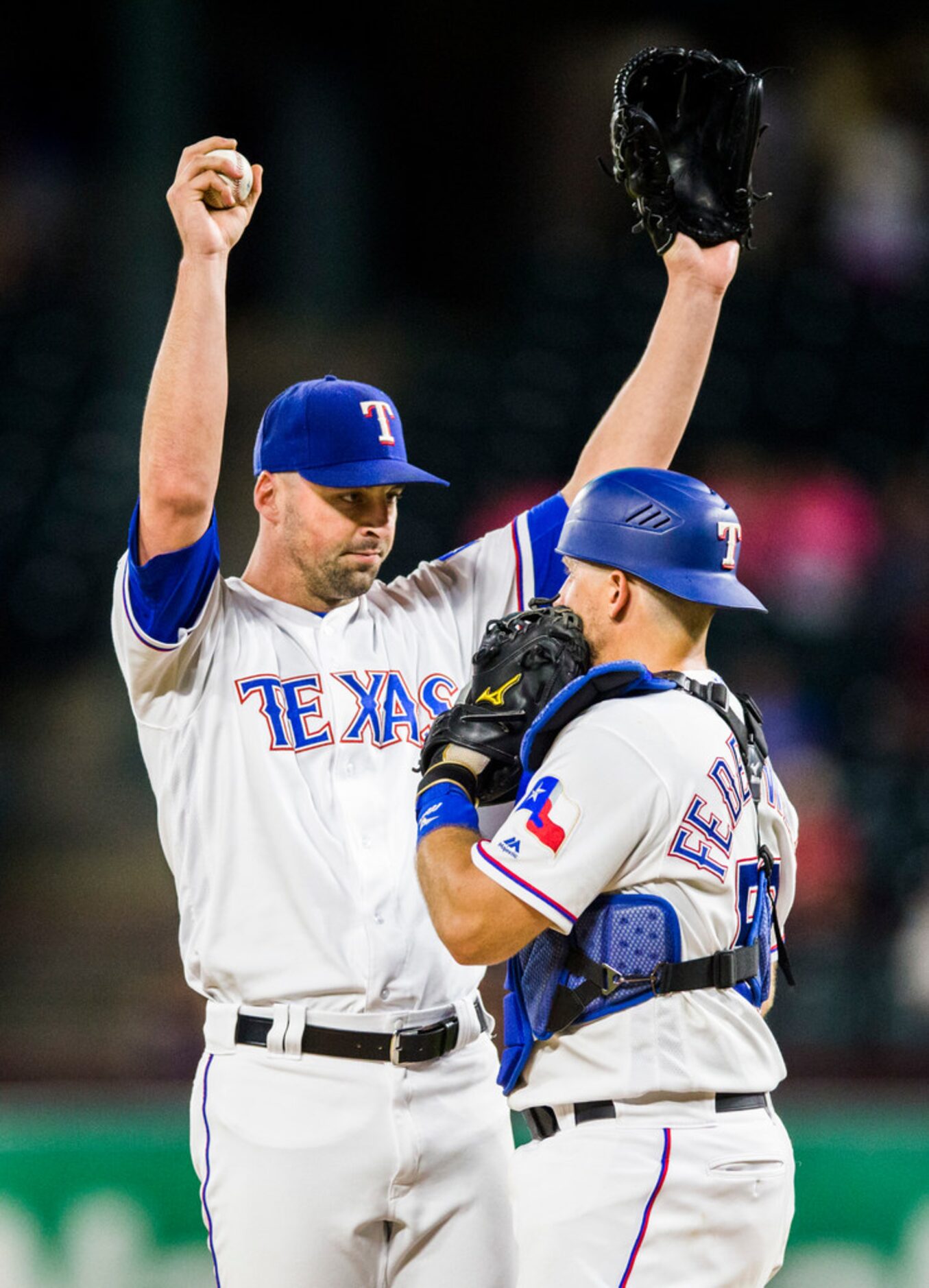 Texas Rangers relief pitcher Taylor Guerrieri (46) raises his arms while talk to catcher Tim...