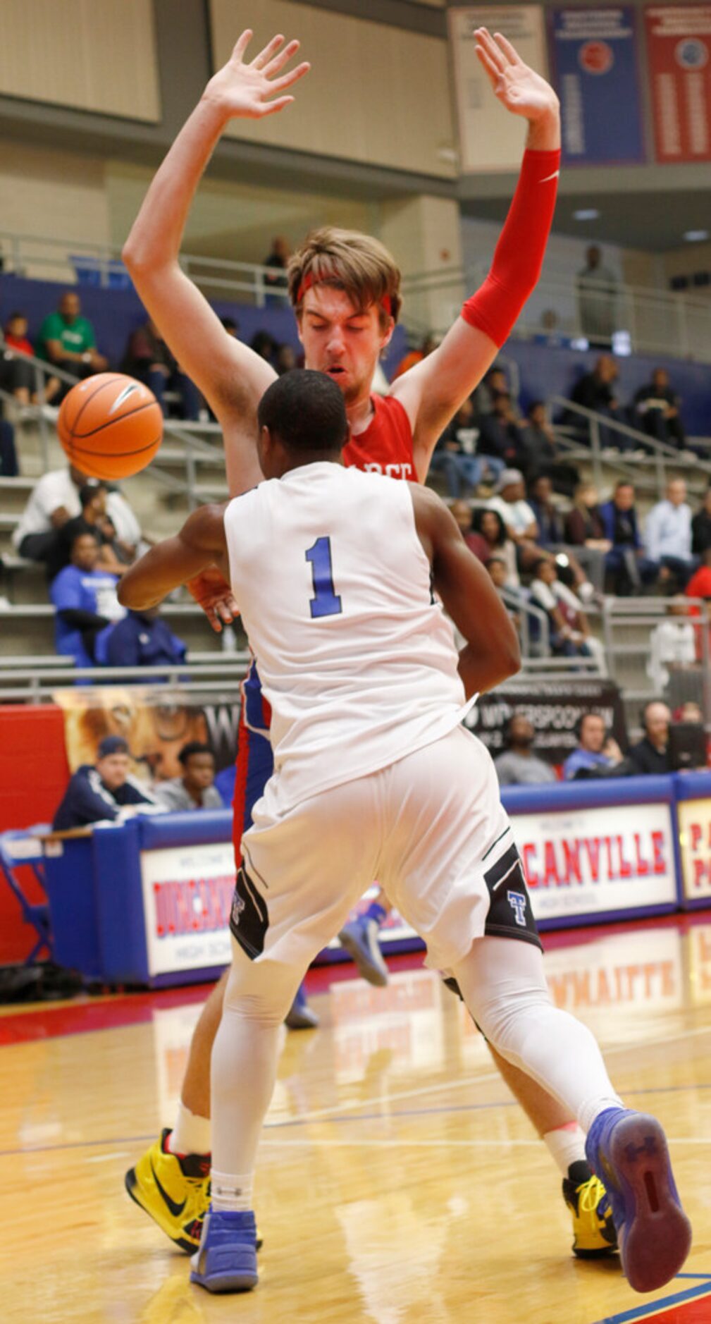 Trinity Christian guard Isaiah Range (1) reaches around Richardson JJ Pearce post Drew Timme...