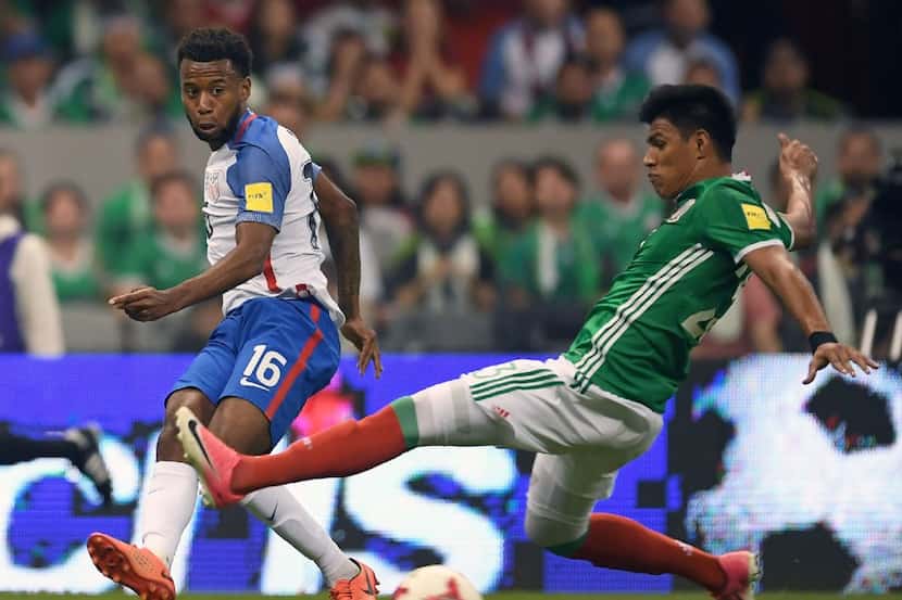 US player Kellyn Acosta (L) is marked by Mexico's Jesus Gallardo during their 2018 FIFA...