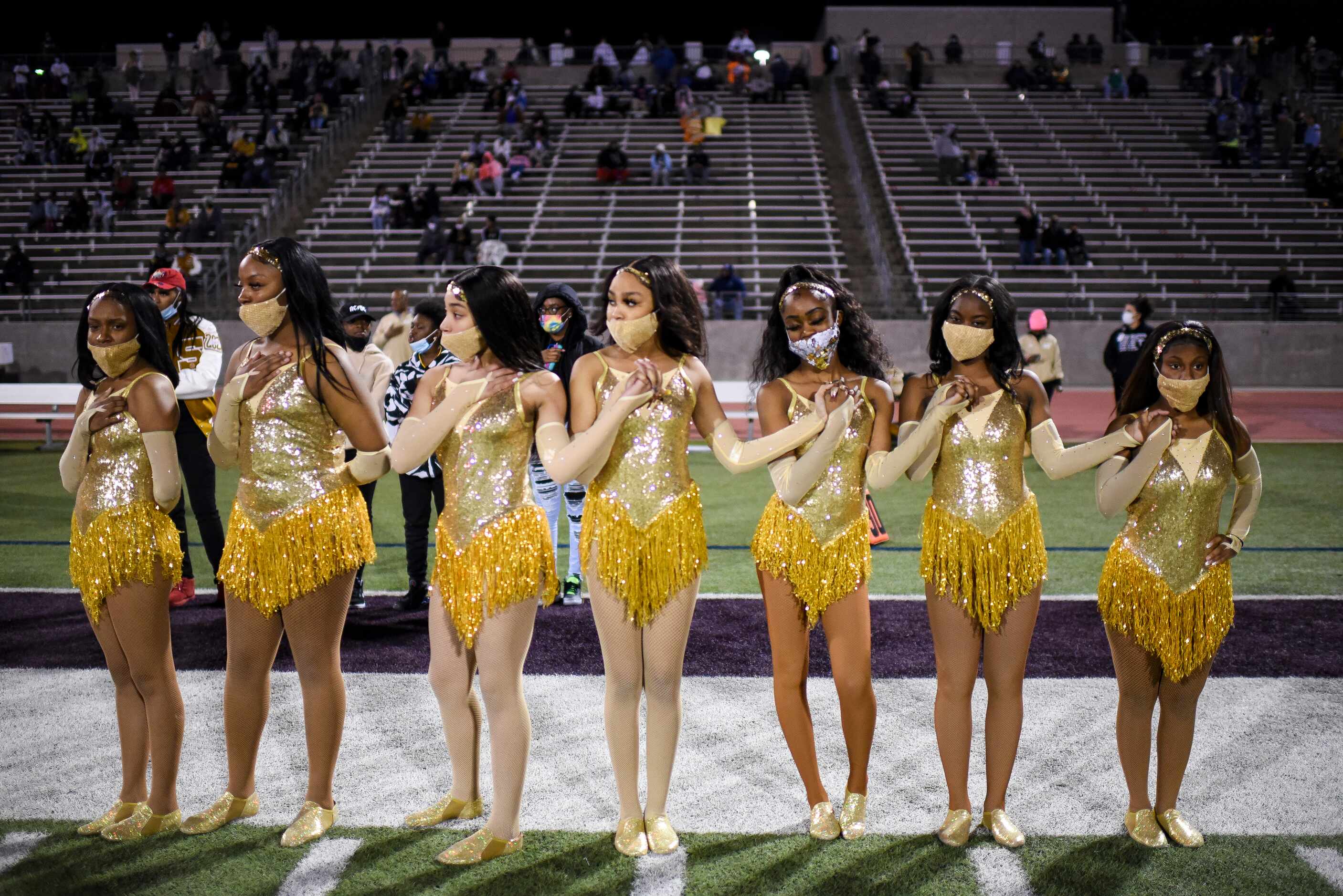 South Oak Cliff dancers hold hands during the Star Spangled Banner prior to the start of the...