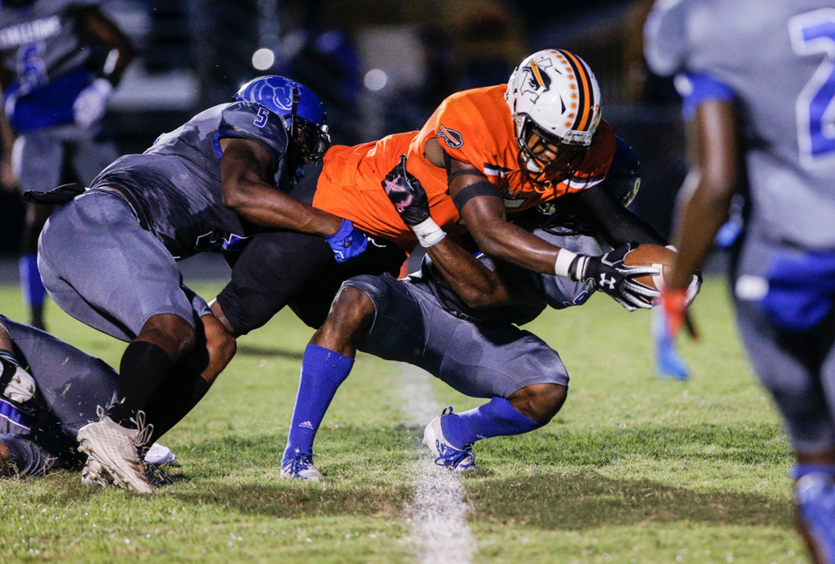 TXHSFB Haltom City senior running back Kenneth Cormier Jr. (5), center, scores a touchdown...