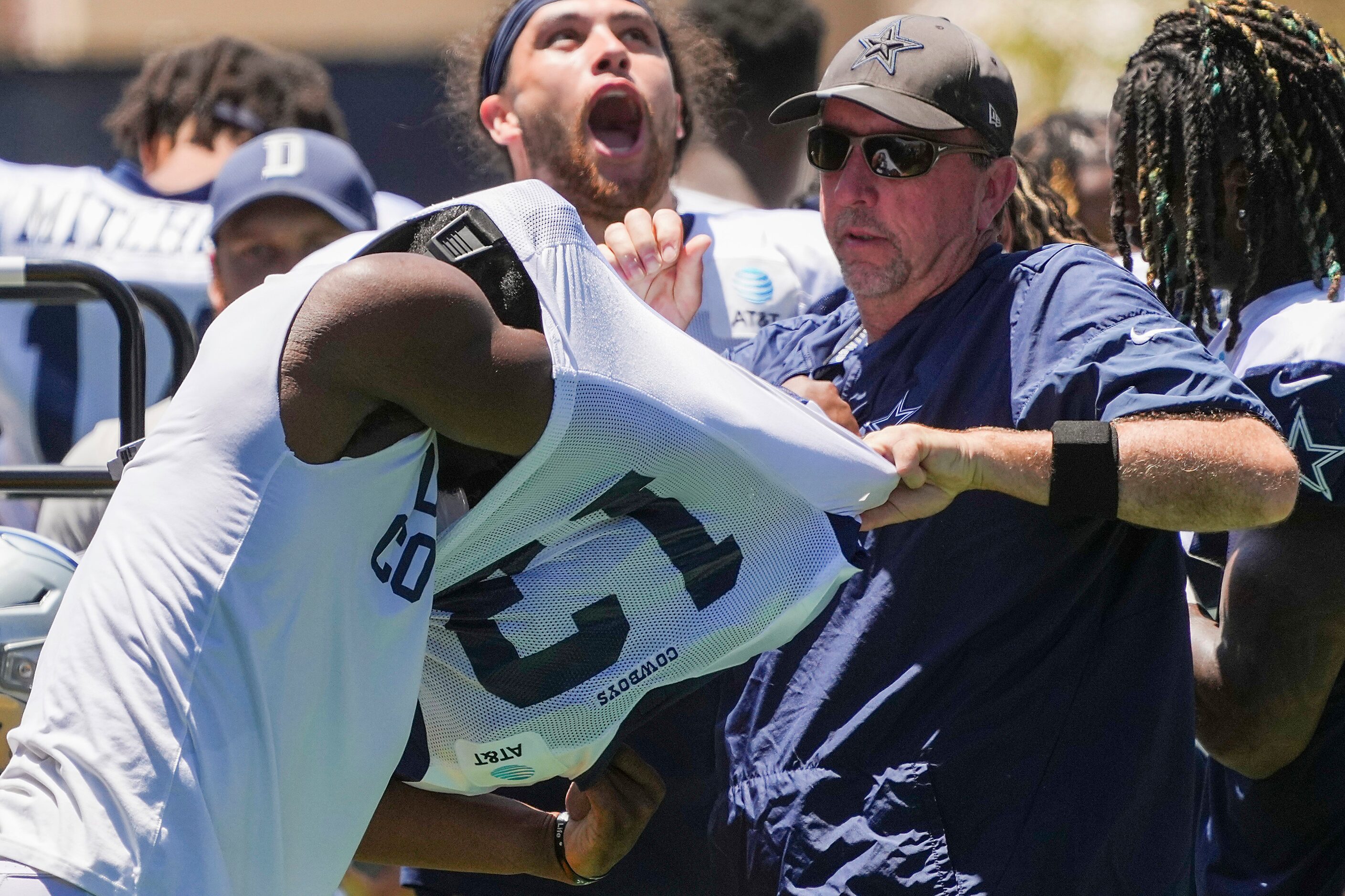 Dallas Cowboys wide receiver Michael Gallup (13) gets help out of his jersey and pads...