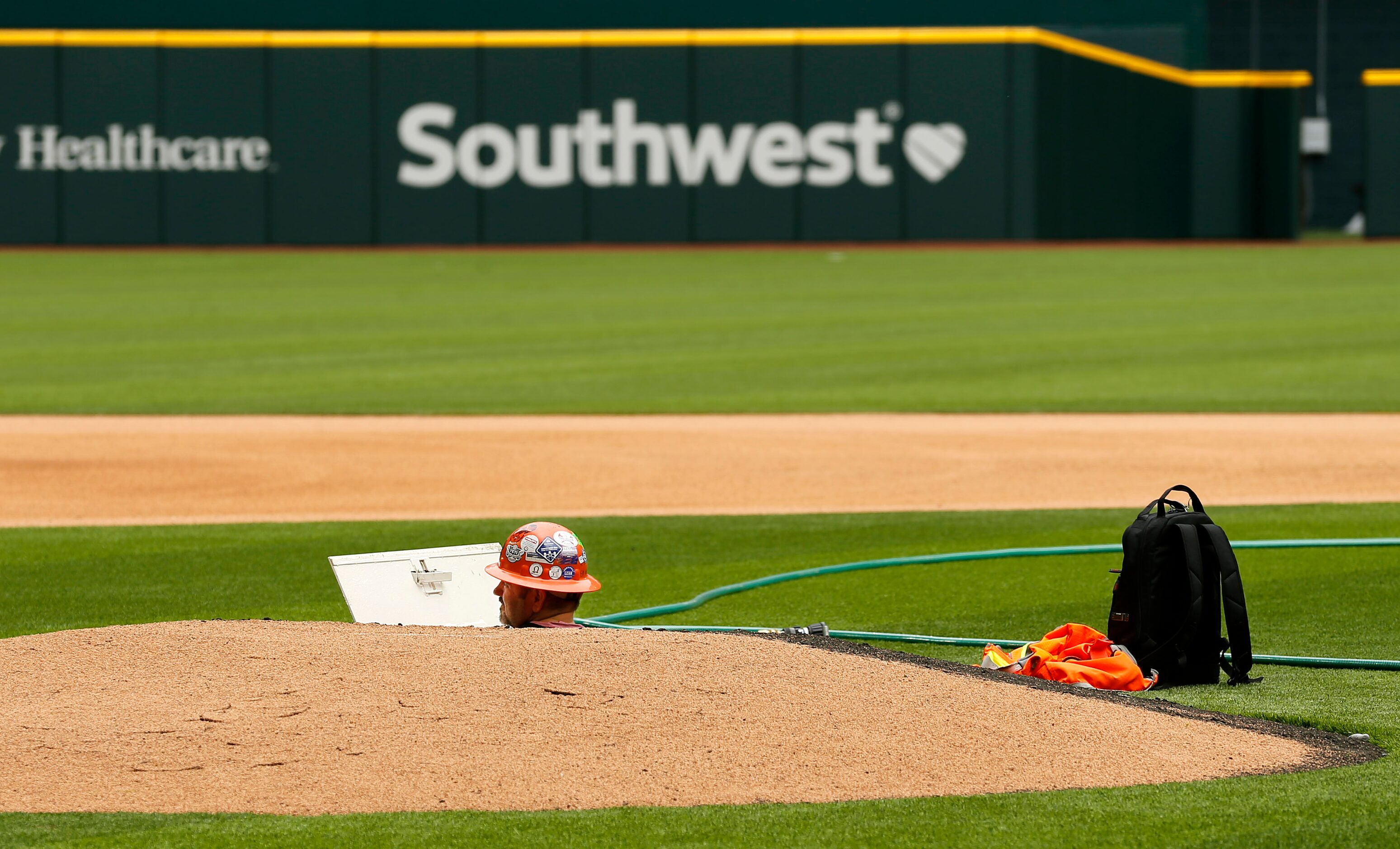 Construction workers peeks out of the pitching mound at the newly completed Globe Life Field...