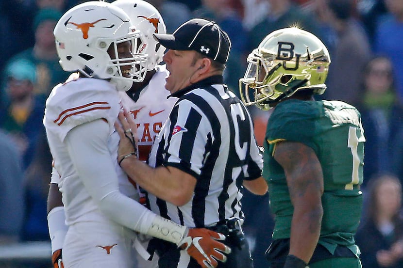 Center Judge Stacy Hardin, center, separates Baylor wide receiver Corey Coleman (1) and...