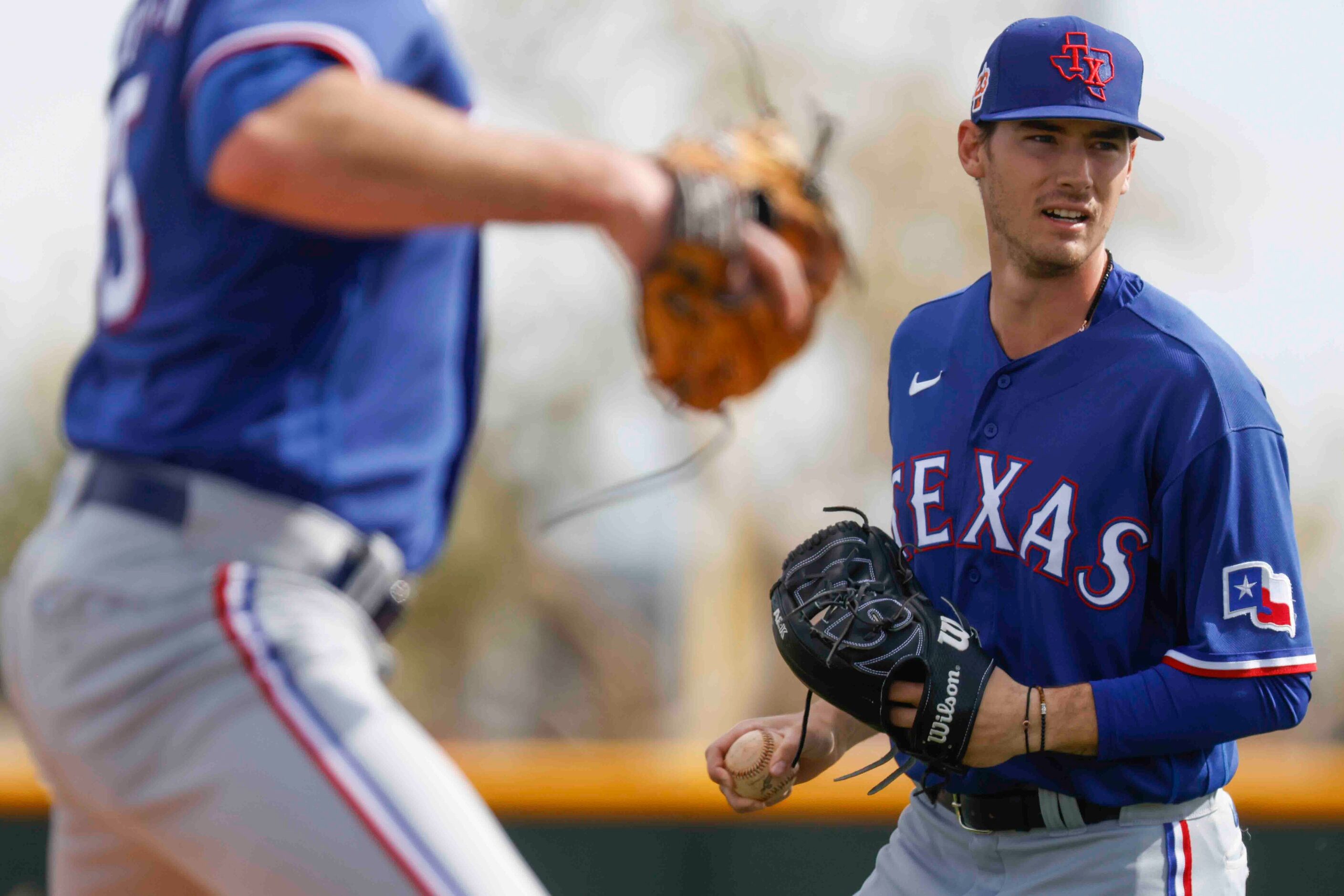 Texas Rangers pitcher Cole Winn gets set to throw the ball during a spring training workout...