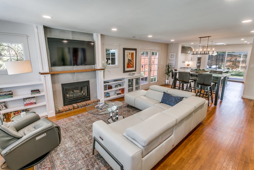 The owners reconfigured the main portion of the house to connect the living room, dining...