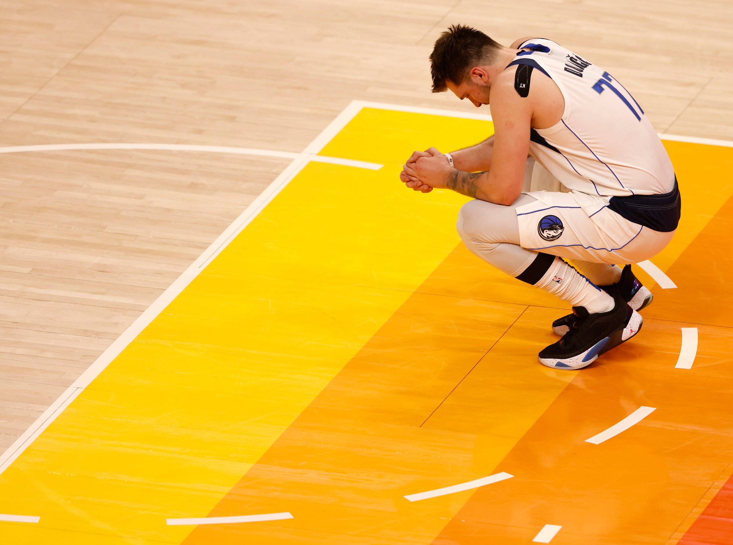 Dallas Mavericks guard Luka Doncic (77) rests at the opposite free throw line as Dallas...