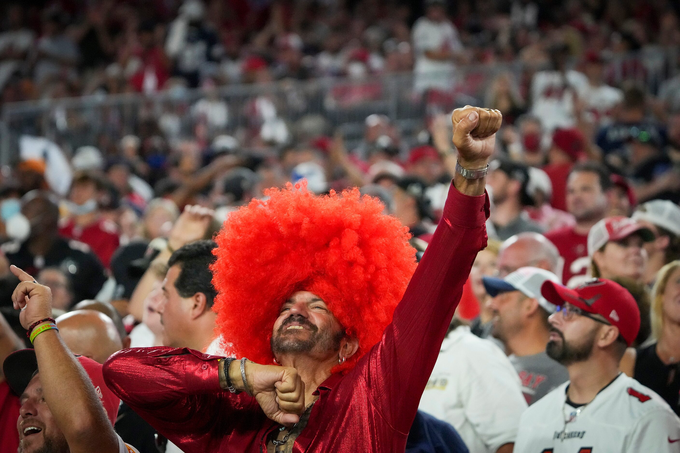 Tampa Bay Buccaneers fans celebrate after Dallas Cowboys place kicker Greg Zuerlein missed a...