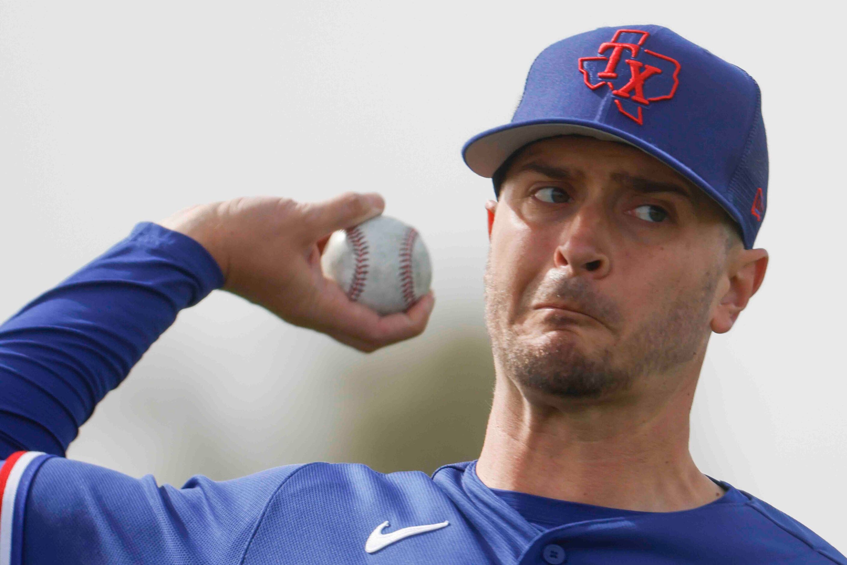 Texas Rangers pitcher Jake Odorizzi throws a pitch during spring training at the team's...