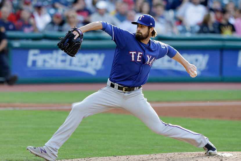 Texas Rangers starting pitcher Cole Hamels delivers in the first inning of a baseball game...