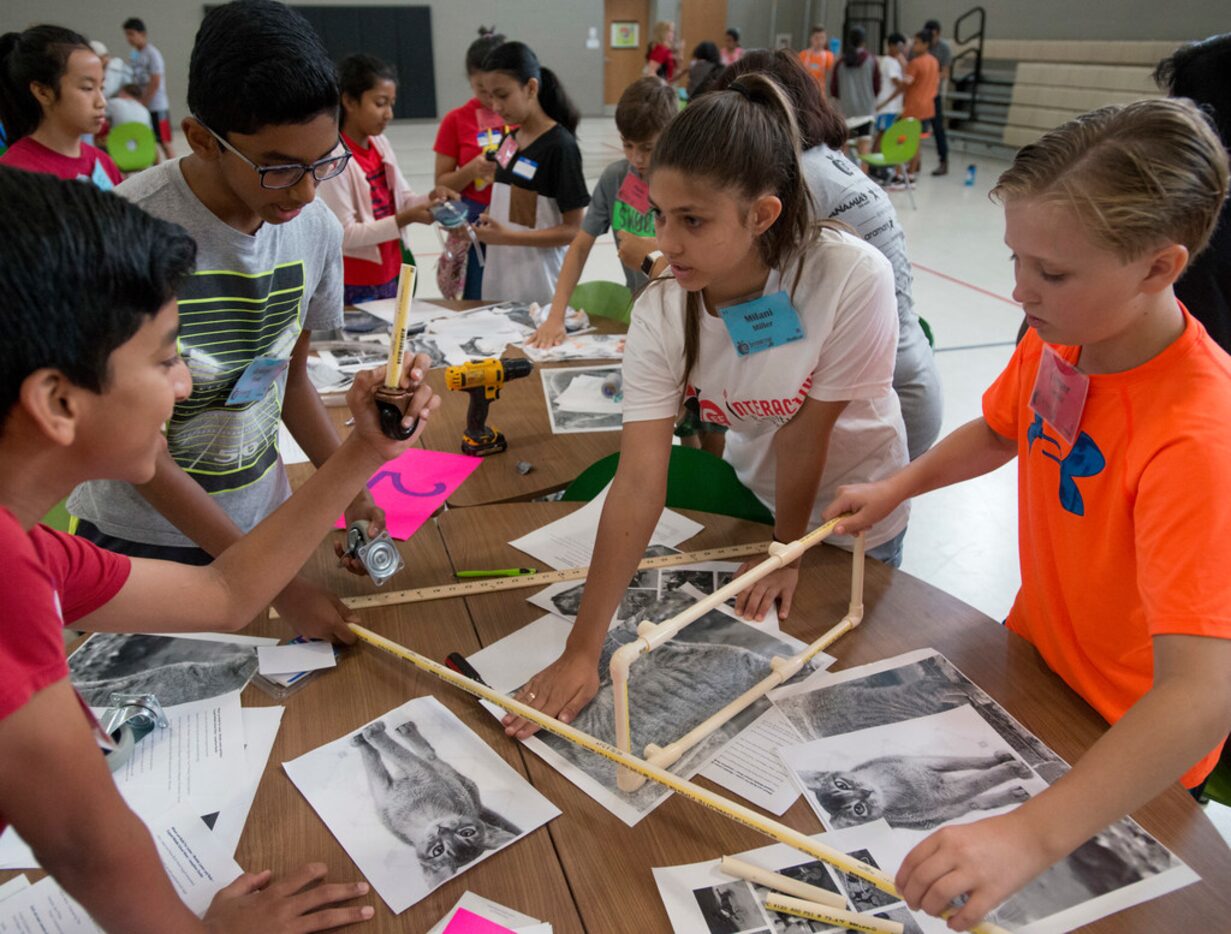 Milani Miller (center) talks with classmates Rithvik Gabri (left), George Paul (second from...