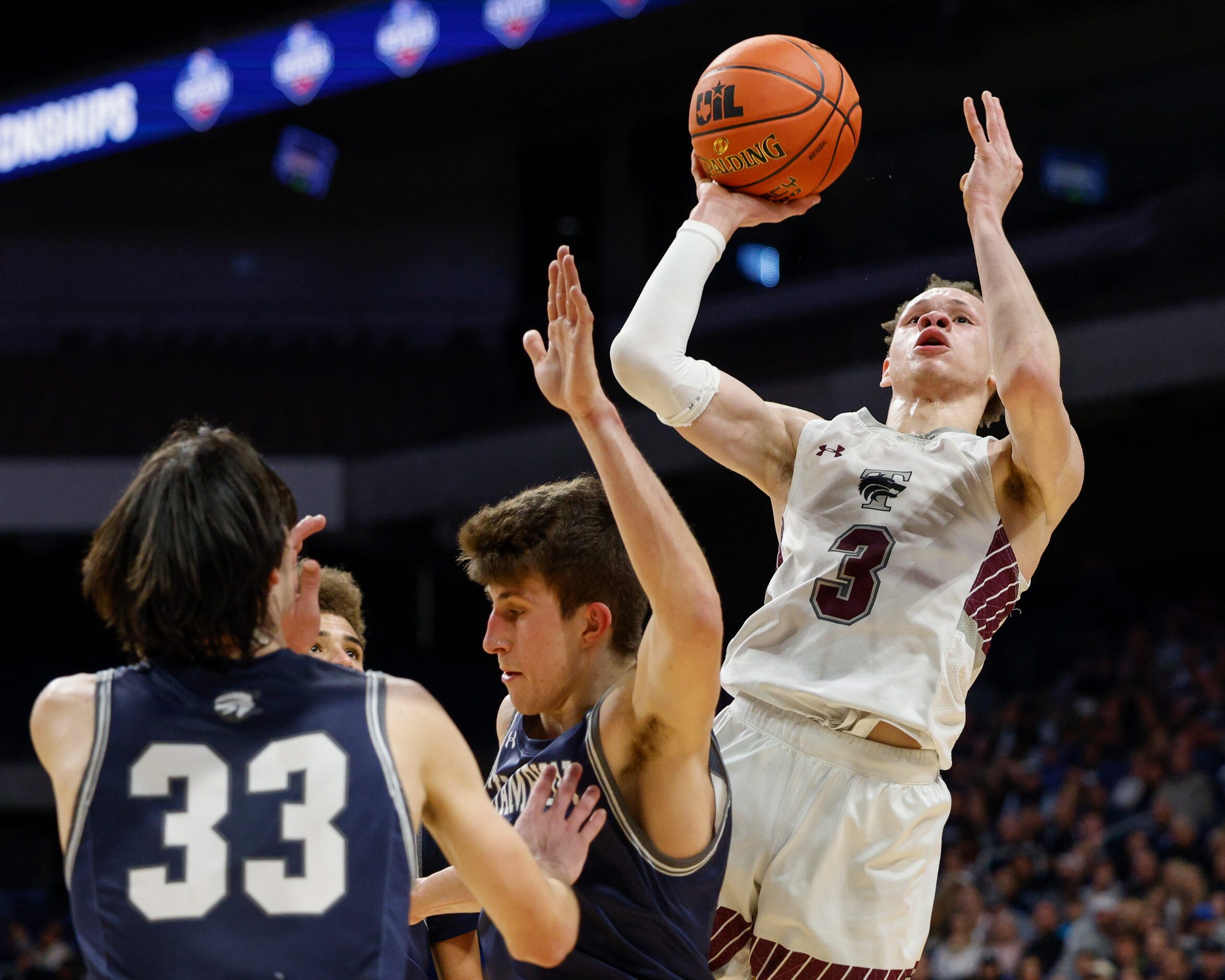 Mansfield Timberview guard Chendall Weaver (3) attempts a layup over Boerne Champion guard...