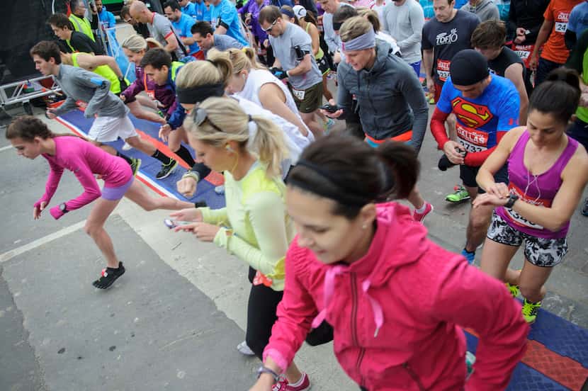 Runners take off as they start the Dallas Rock N' Roll half-marathon on Sunday, March 23,...