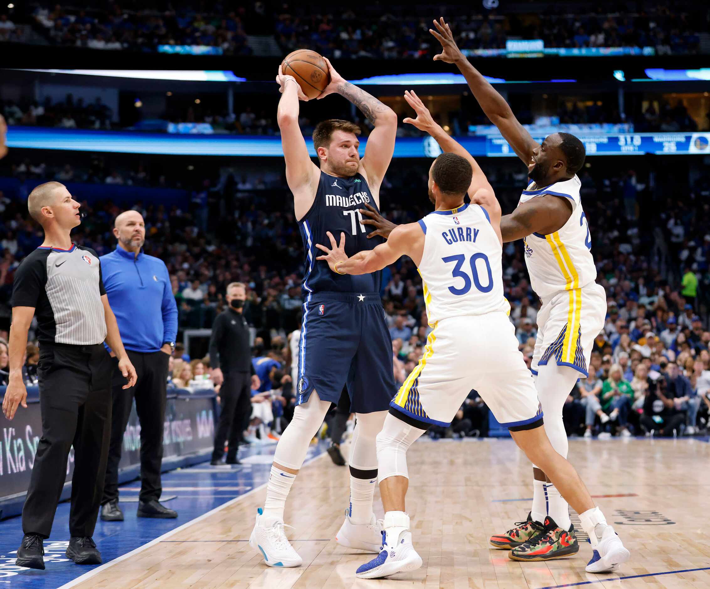Dallas Mavericks guard Luka Doncic (77) is double teamed by Golden State Warriors guard...