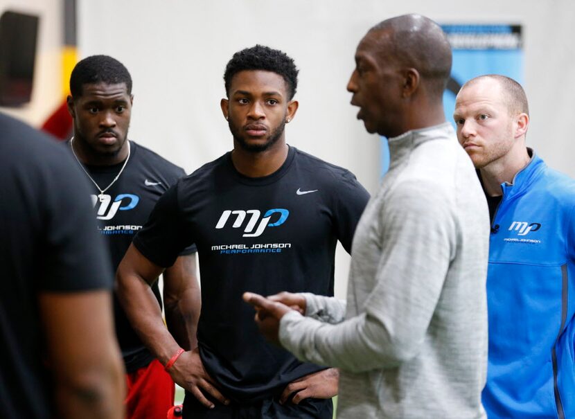 University of Houston's Greg Ward Jr. listens as Michael Johnson talks to the group at...