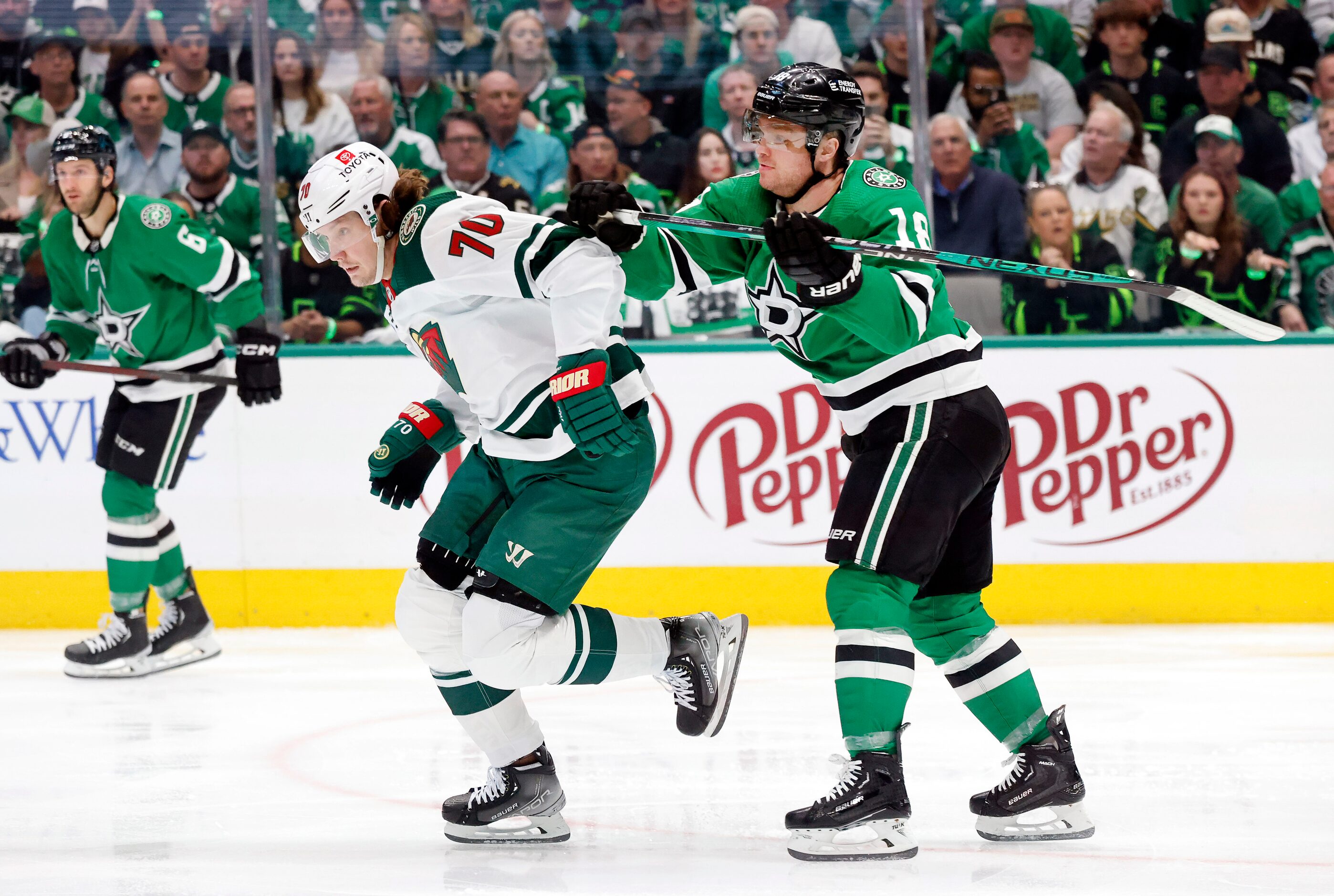 Dallas Stars center Max Domi (18) gives a stick to stickless Minnesota Wild center Oskar...