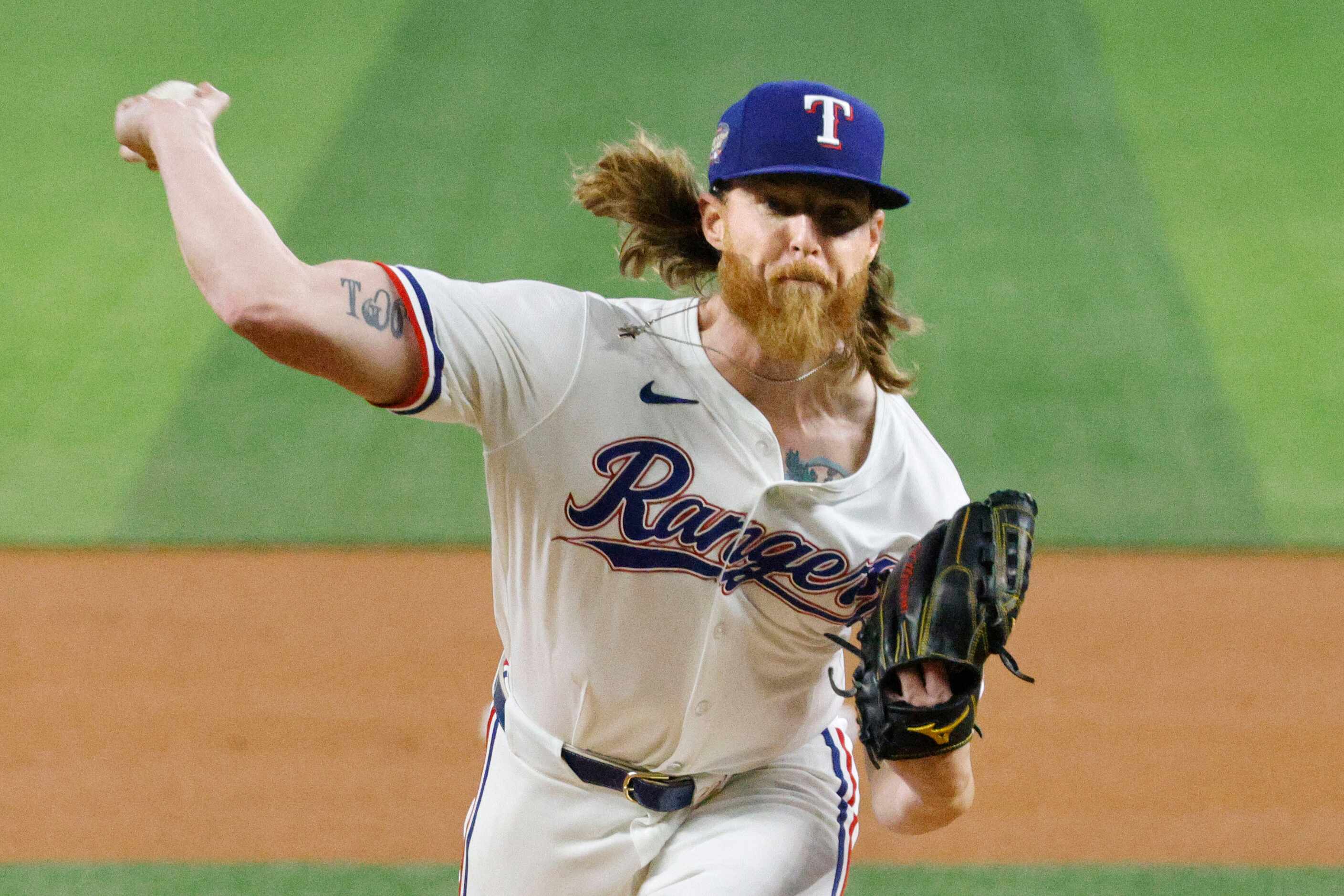 Texas Rangers pitcher Jon Gray (22) delivers during the first inning of a baseball game...