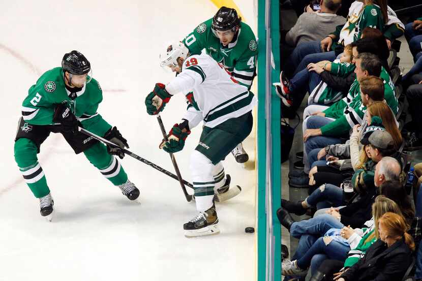 Fans watch as Dallas Stars defenseman Dan Hamhuis (2) and left wing Remi Elie (40) try to...