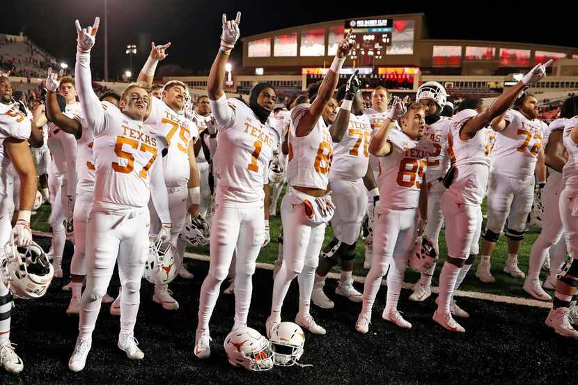 Texas players sing the school song after an NCAA college football game against Texas Tech,...