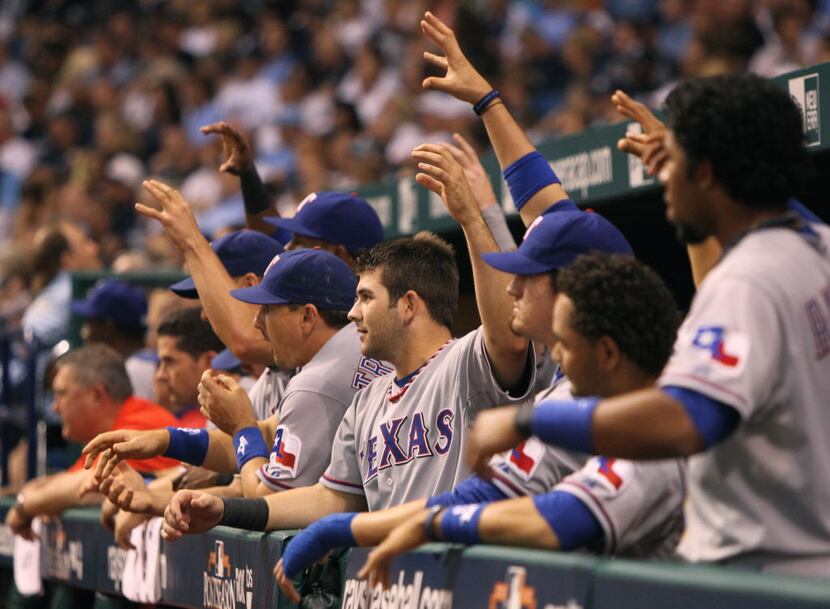 Texas Rangers players make "the claw" during their game against the Tampa Bay Rays during...