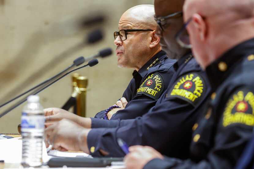 Dallas police Chief Eddie Garcia (left) presents updated violent crime statistics to the...