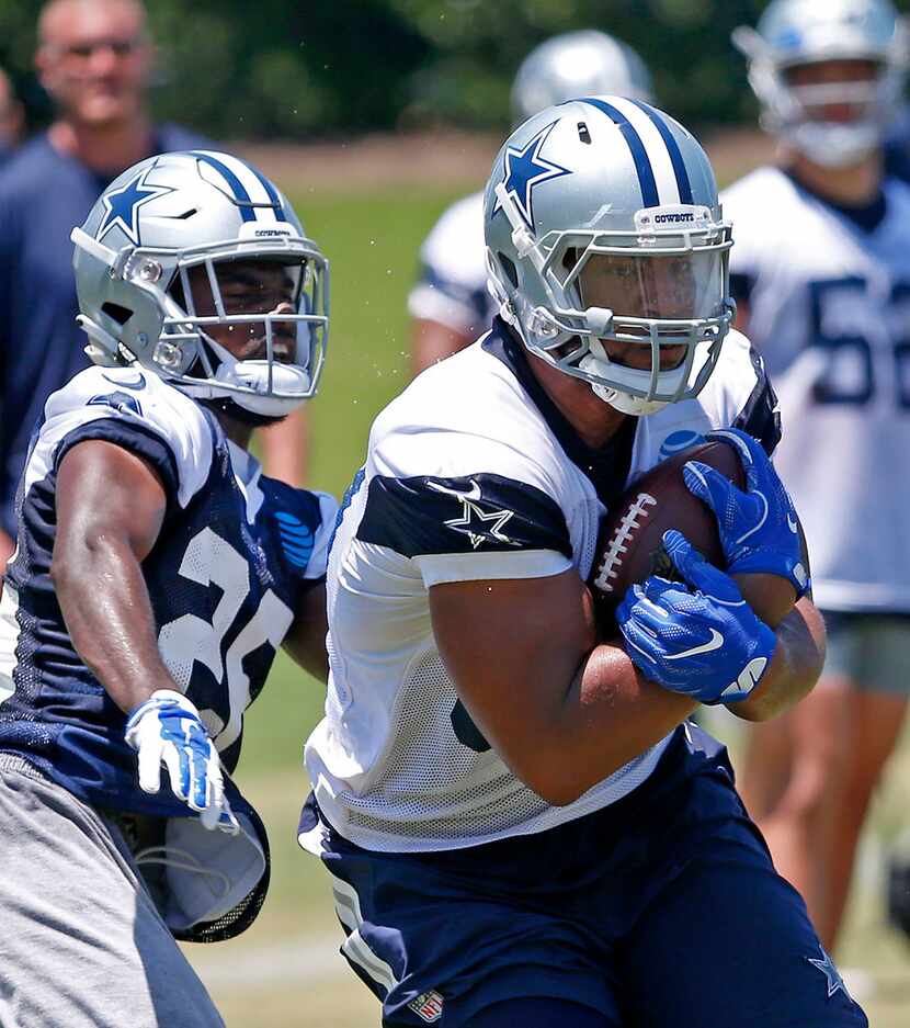 Dallas Cowboys tight end Rico Gathers (80) powers cornerback Duke Thomas during OTA practice...