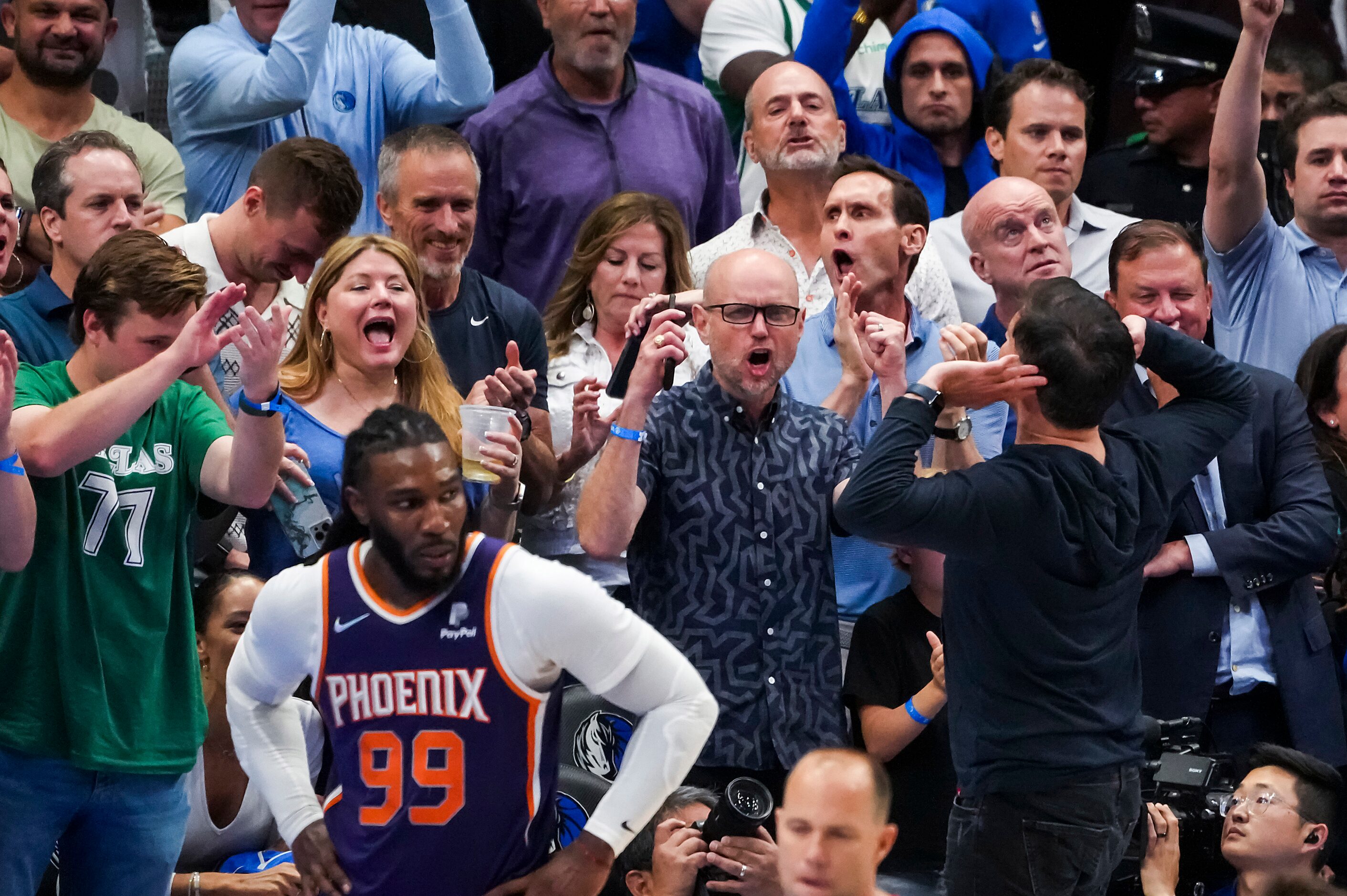 Dallas Mavericks owner Mark Cuban engourages the crowd to get louder as Phoenix Suns forward...