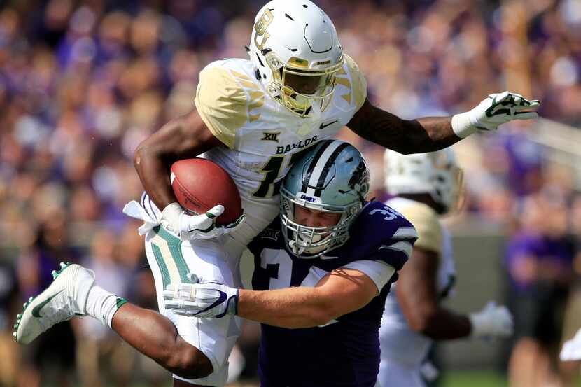 Baylor wide receiver Tony Nicholson (13) is tackled by Kansas State defensive end Tanner...