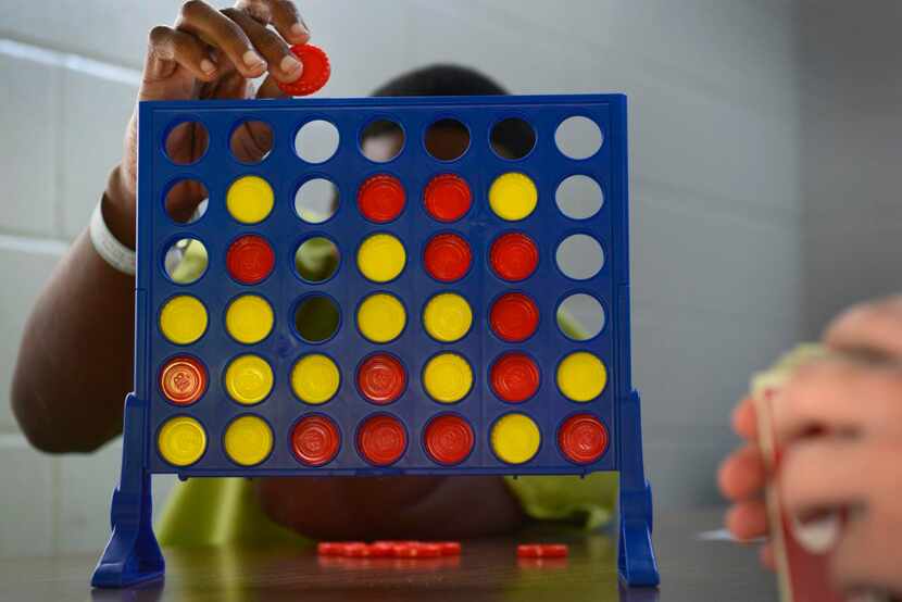 
A boy drops a chip in a game of Connect Four at the Henry Wade Juvenile Justice Center in...