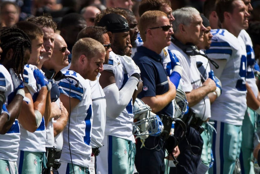 Dallas Cowboys stand for the national anthem before the first half of an NFL football game...