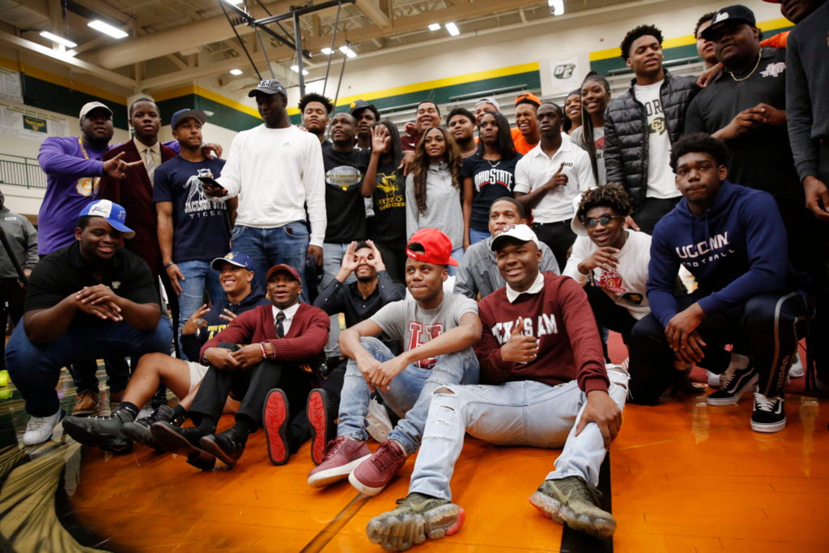 Signees pose for a photograph after signing on National Signing Day at DeSoto High School on...