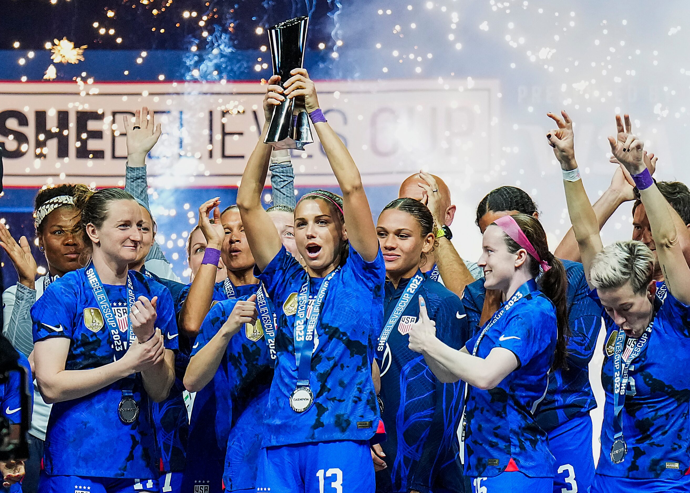 United States forward Alex Morgan (13) raises the trophy after a victory over Brazil in the...