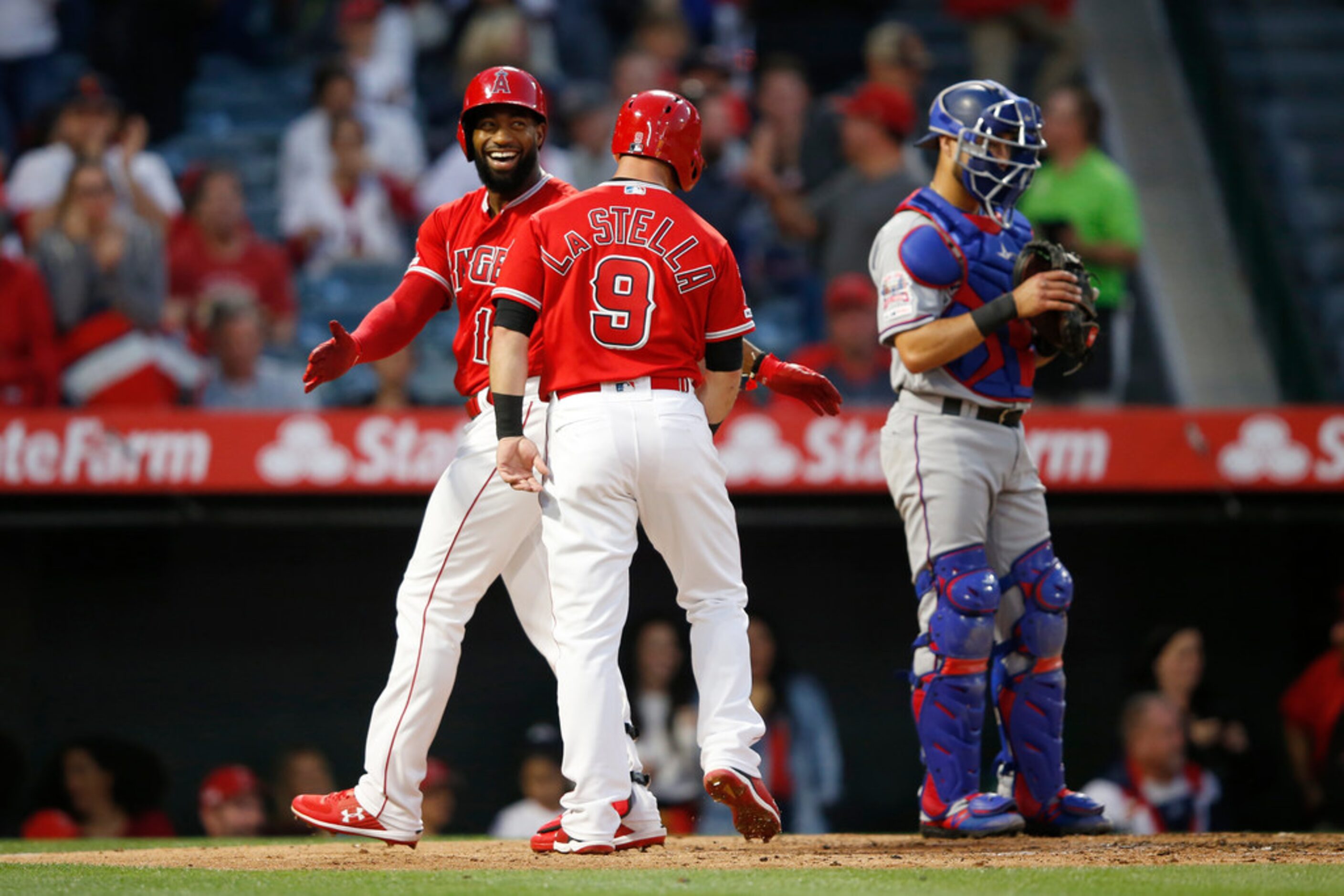 ANAHEIM, CALIFORNIA - MAY 24:  Tommy La Stella #9 congratulates Brian Goodwin #18 of the Los...