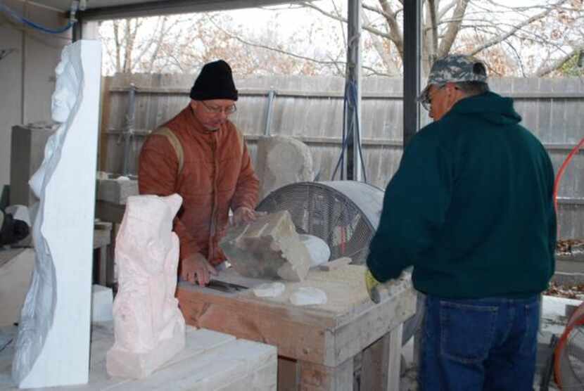 
Art Wells (left) prepares to demonstrate stone sculpting techniques to student Robert...