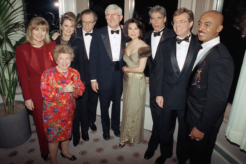 Talk show host Phil Donahue, center, poses with other television personalities after the...