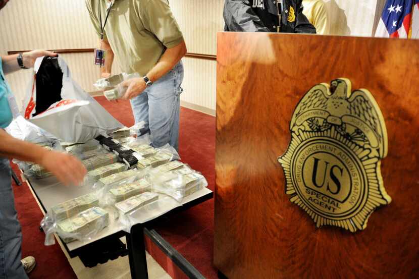 Drug Enforcement Administration field agents pack up cash in Atlanta that was confiscated...