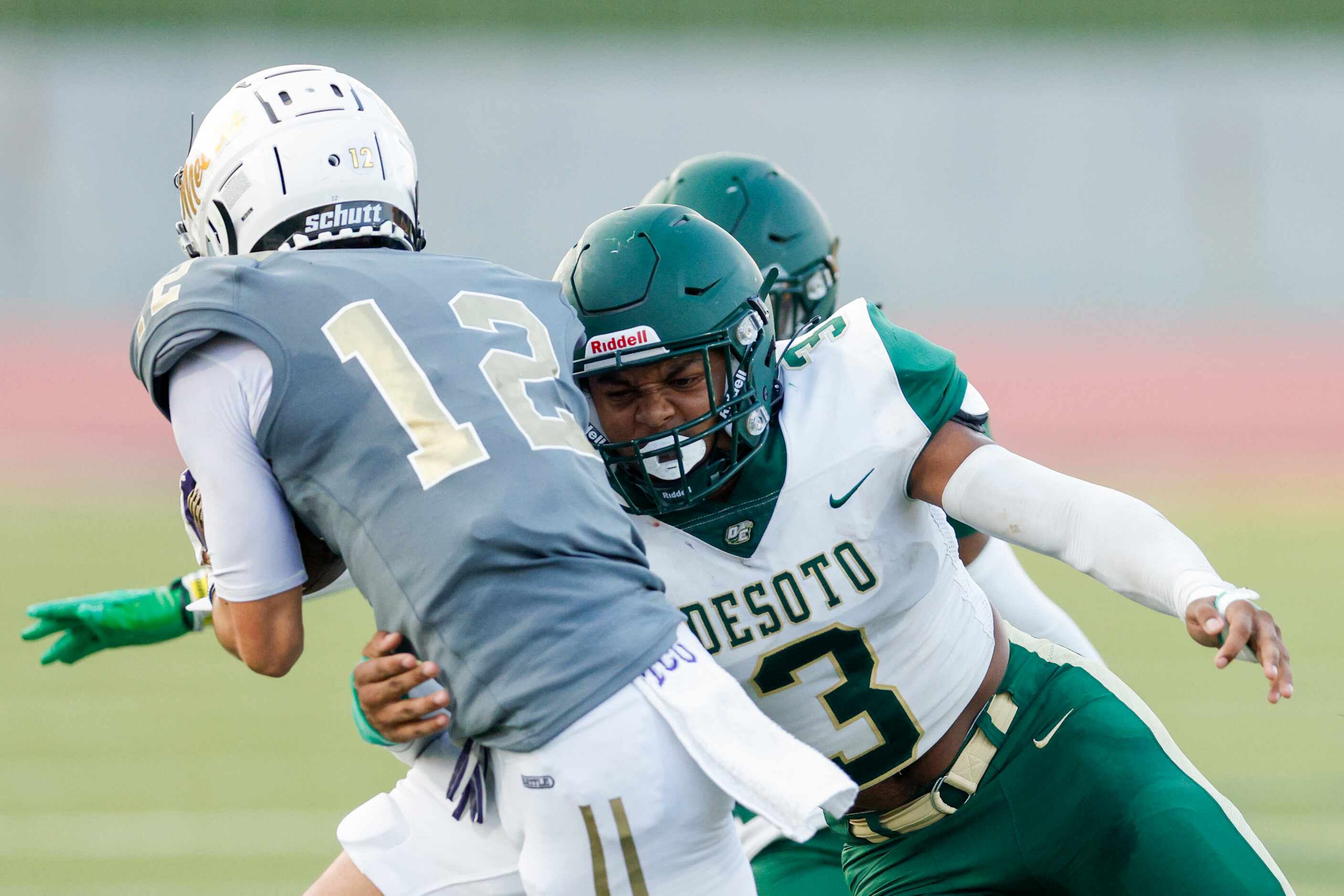 DeSoto linebacker Brandon Booker (3) tackles South Oak Cliff quarterback Carter Kopecky (12)...