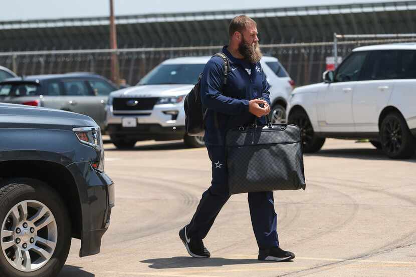 Dallas Cowboys center Travis Frederick arrives to board the team charter to depart for...